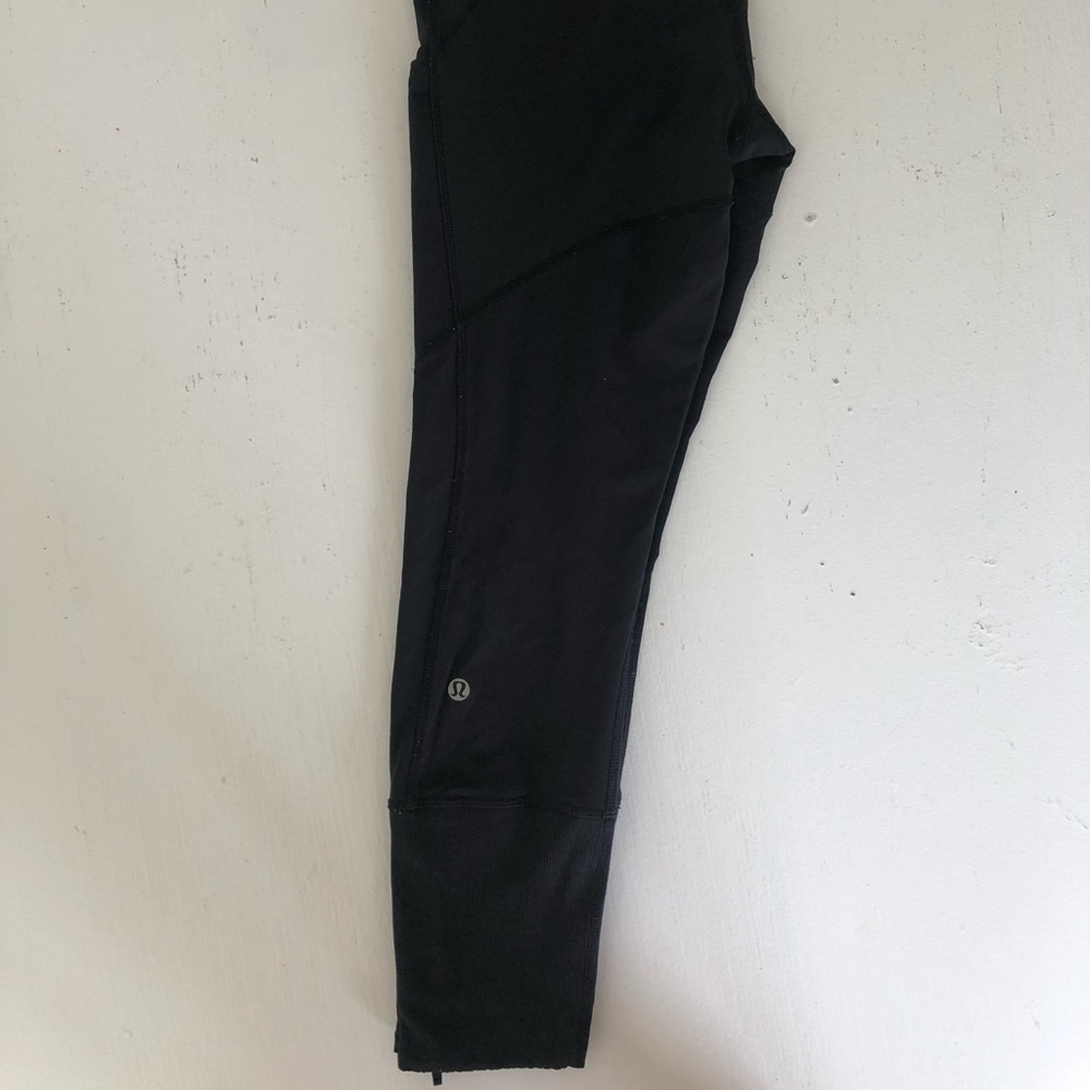 Lululemon black leggings with pockets and zippers at bottom of legs